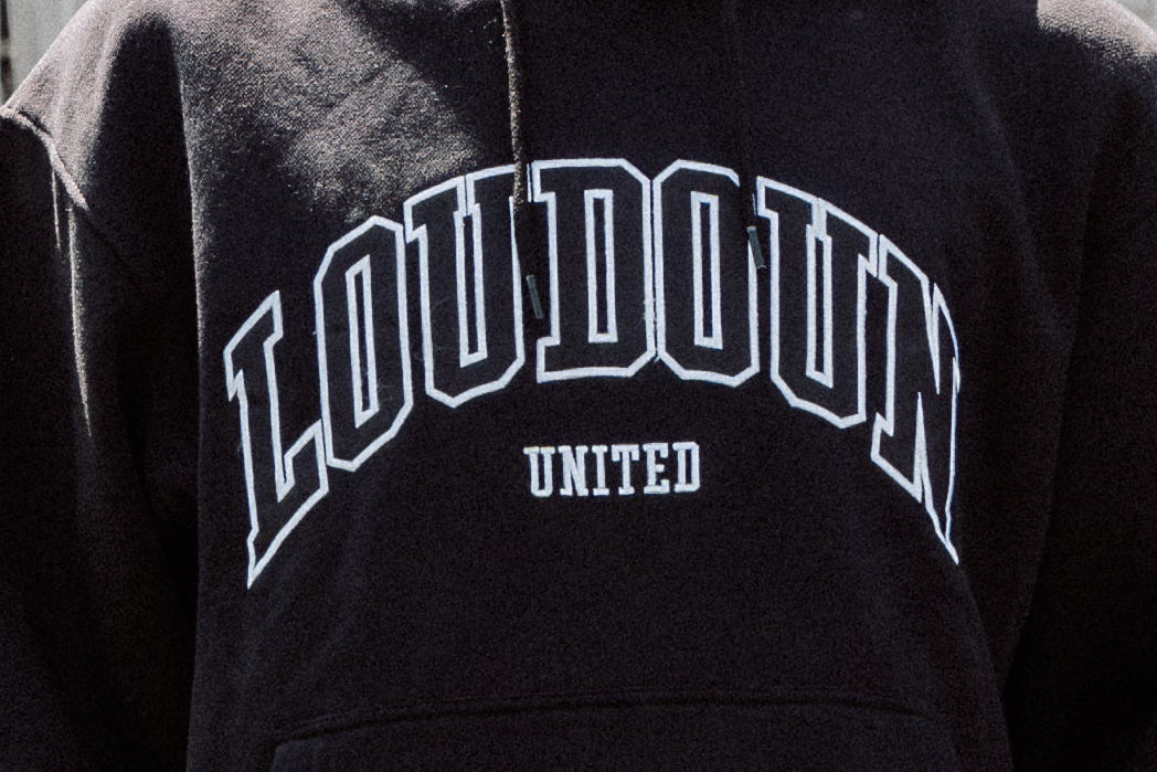 Black hoodie with 'LOUDON UNITED' text on a dark background